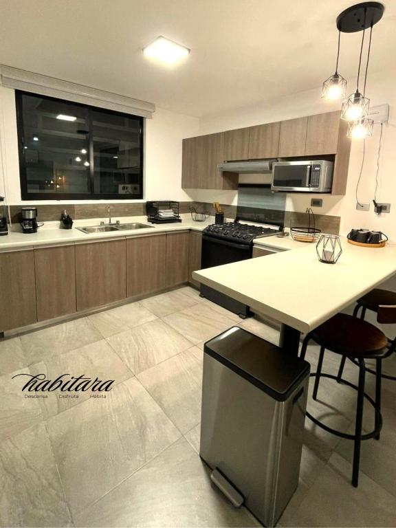 a large kitchen with a table and chairs in it at Habitara - Carancho in Atasta de Serra
