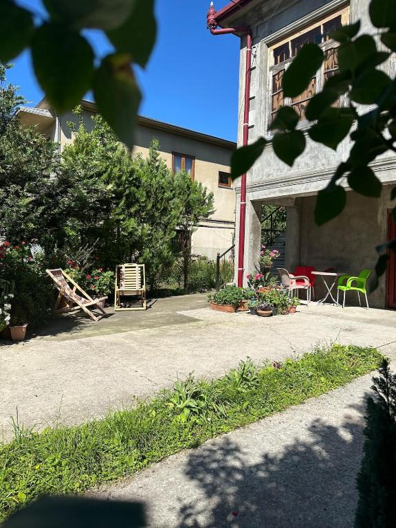 a building with a patio with a table and chairs at Maryams Studio Guesthouse in Zugdidi