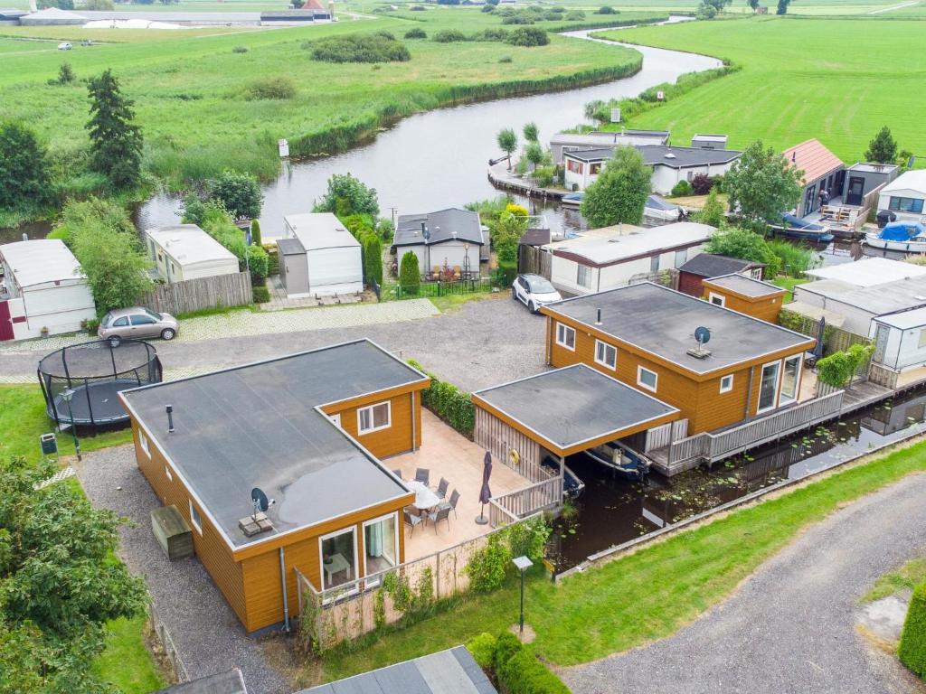 an aerial view of a house and a river at Sluisje 15 in Kuinre