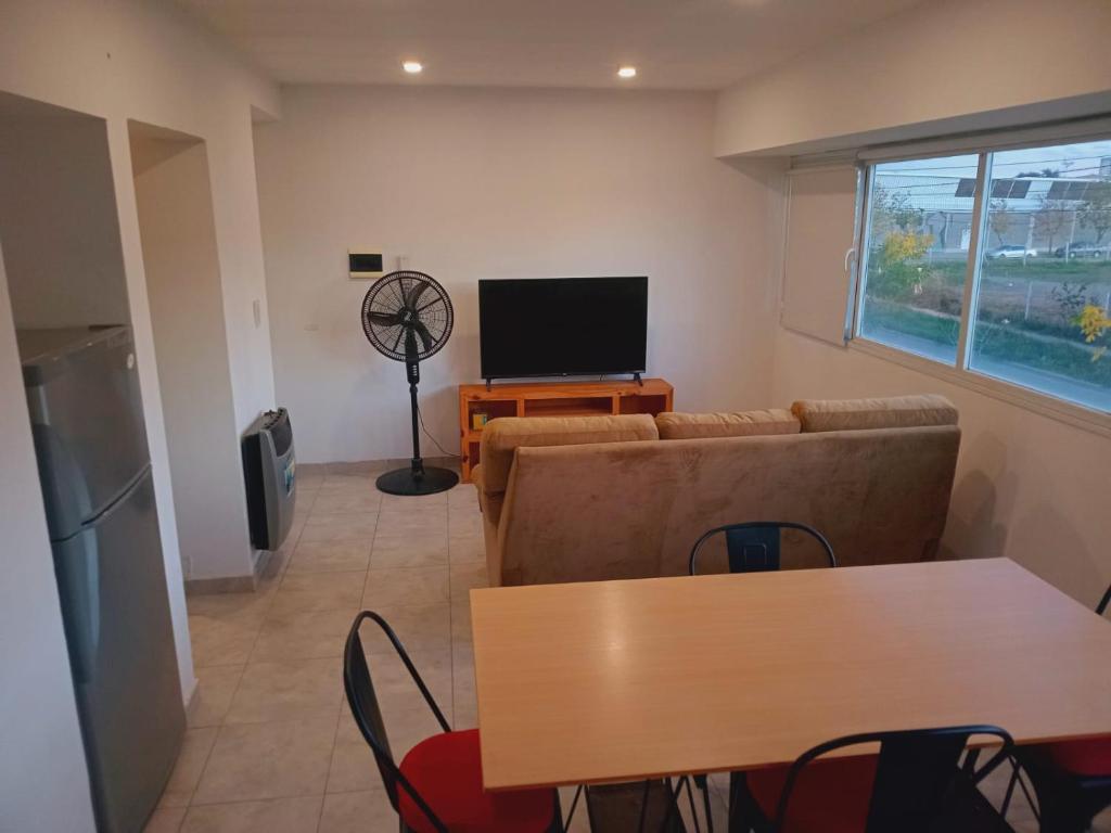 a living room with a couch and a table and a television at Bernal Alquileres in Viedma