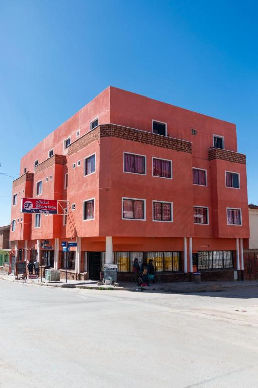 a red brick building on the corner of a street at Hotel Frontera in La Quiaca