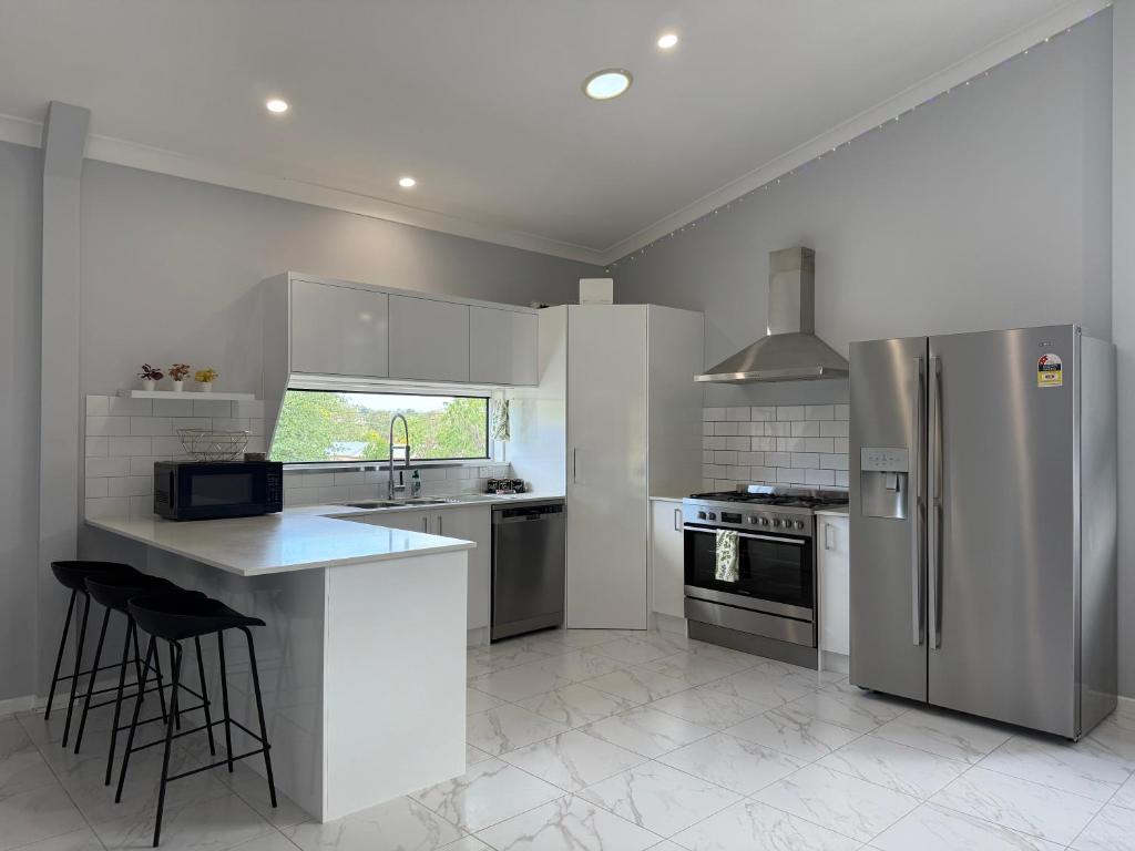 a kitchen with stainless steel appliances and a counter at The Green Shouse in Stanthorpe
