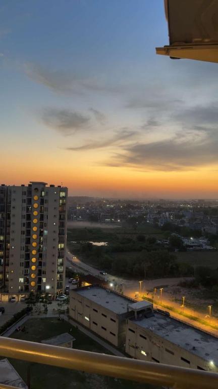 a view of a city at night with buildings at Skypod13 in Chandīgarh