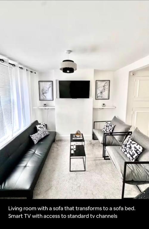 a living room with a couch that transforms to a sofa bed at Medway Hidden Gem in Gillingham