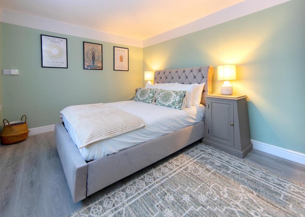 a bedroom with a large bed with two lamps on it at Private 2 Bed Escape with Huge Parking in Ely