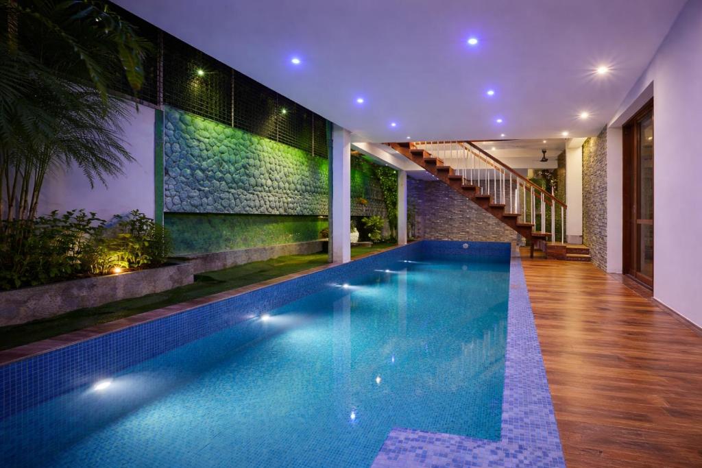 a swimming pool in the middle of a house at Cascade View in Cochin