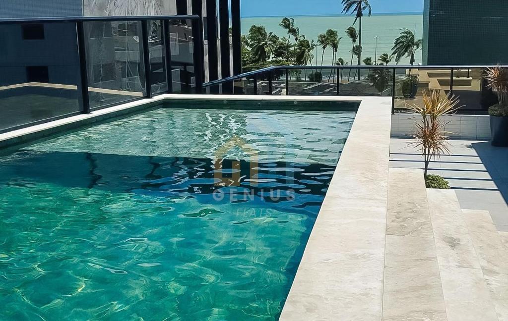 a swimming pool in the middle of a building at Mahalo Flat Cabo Branco Genius Flats in João Pessoa