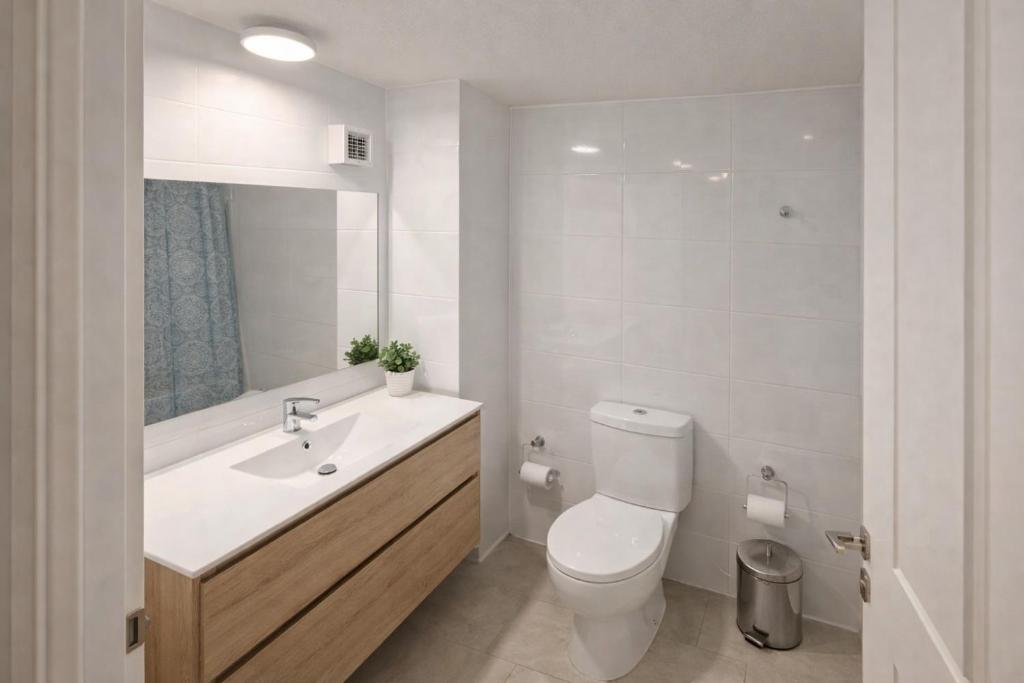 a white bathroom with a sink and a toilet at Edificio iquique obispo labbe 830 in Iquique