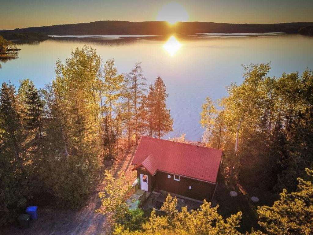 an aerial view of a cabin on the shore of a lake at Le Huard - Lakefront & Private Dock in Sayabec