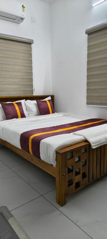 a bedroom with a wooden bed in a room at IRIS urban stay in Cochin