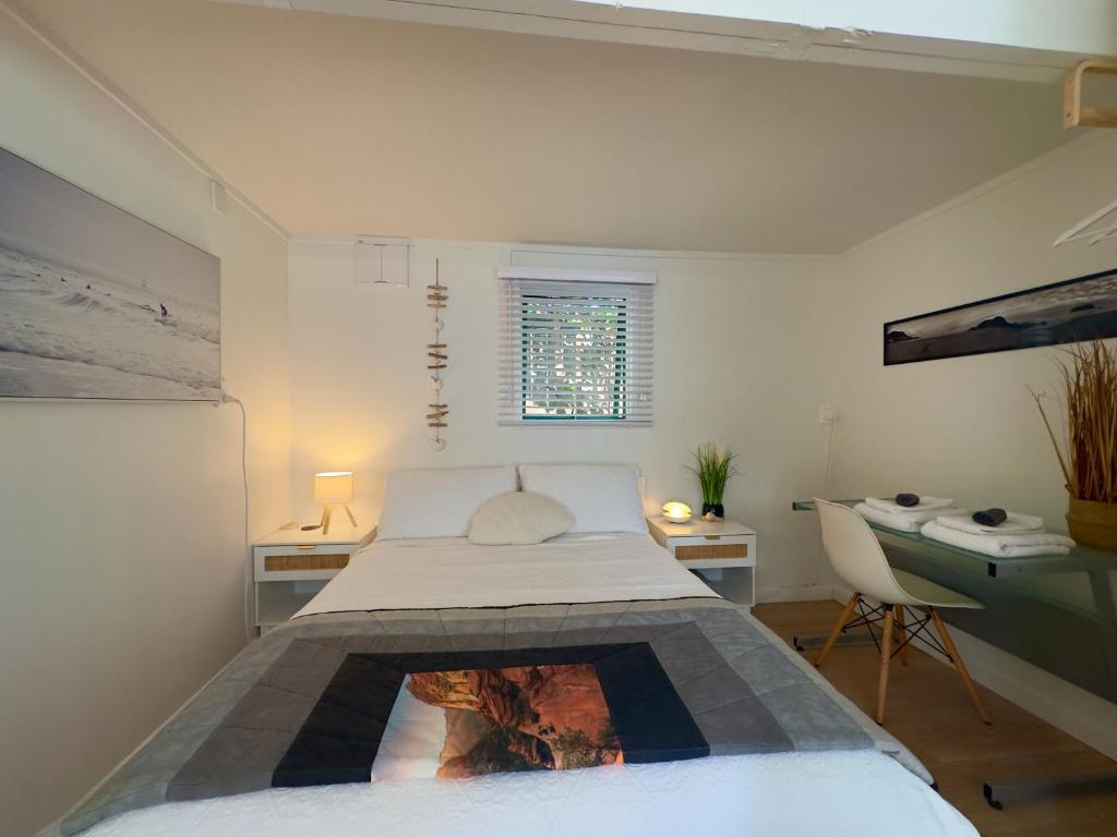 a bedroom with a bed and a fireplace in it at Turtle Cabin in Papamoa