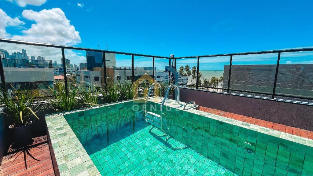 a swimming pool on the roof of a building at Áurea Bauten Cabo Branco Genius Flats in João Pessoa