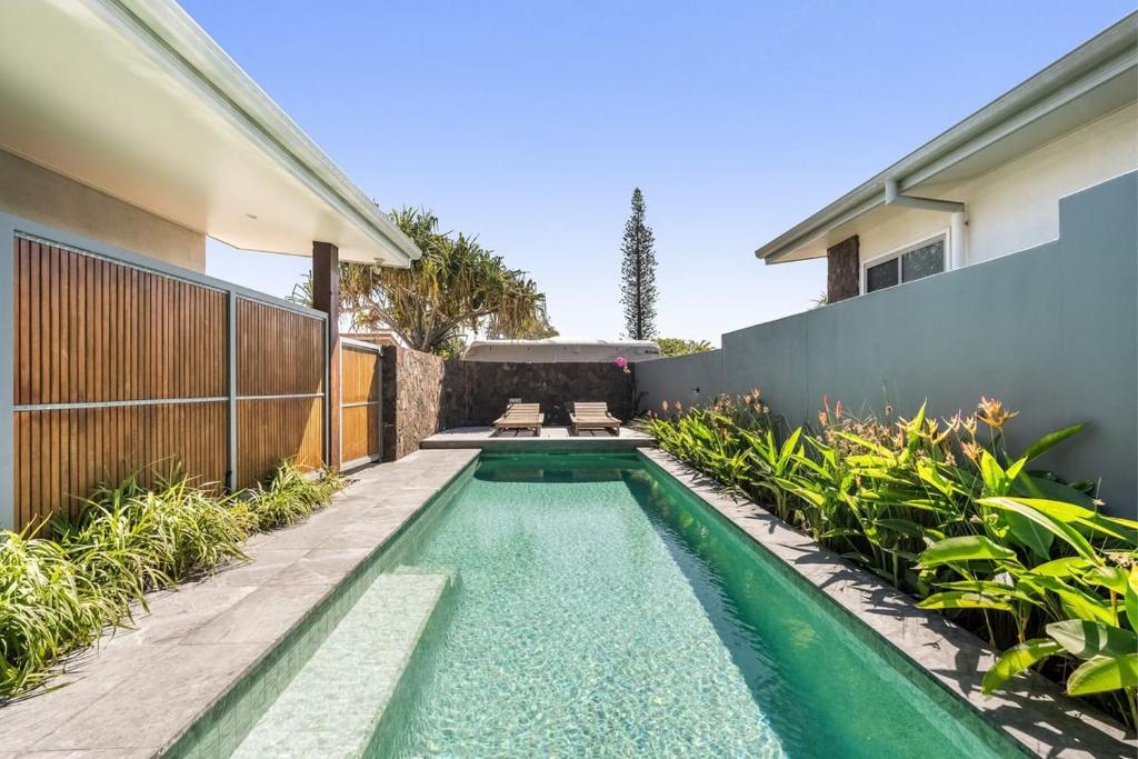 a swimming pool in the backyard of a house at Beachside Banksia in East Ballina