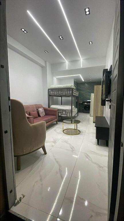 a living room with a couch and a bed at 6th october luxury studio 2 in 6th Of October