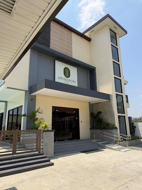 a building with the entrance to a building at Apples&Pears Hotel in Manaoag