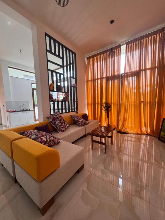 a living room with a couch and a table at Colombo - Kelaniya House in Kelaniya