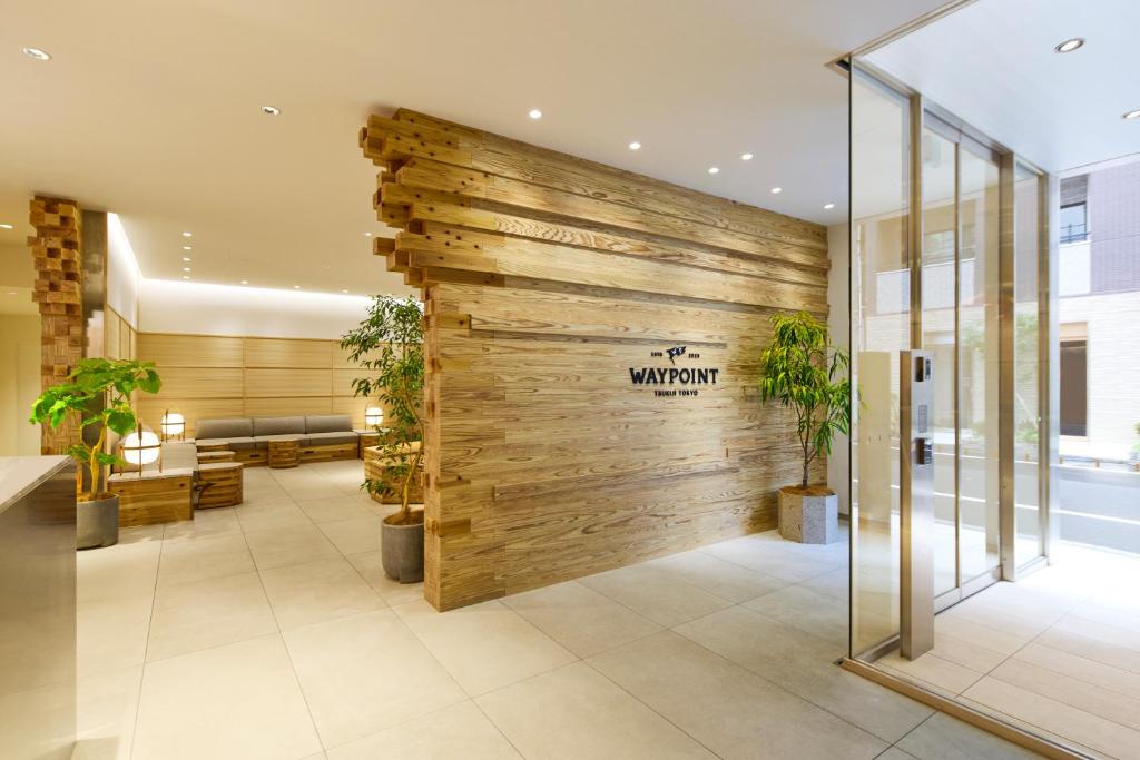 a lobby with a wooden wall in a building at WAYPOINT TSUKIJI Tokyo in Tokyo