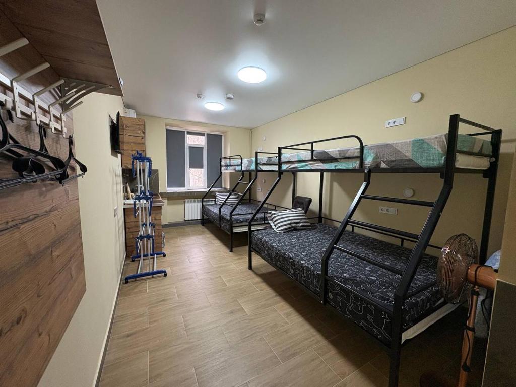 a room with three bunk beds in a room at Apart Rooms & Hostel 5 Capsule Rooms in Ustʼ-Kamenogorsk