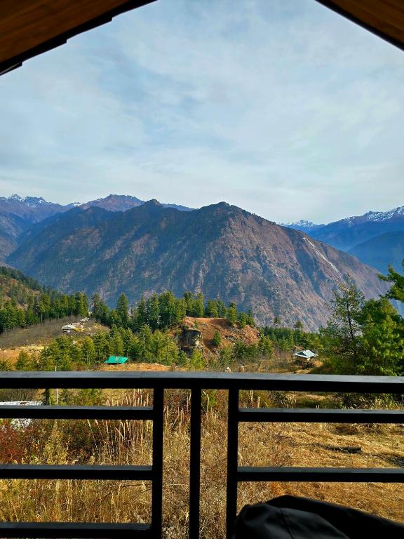 a view of a mountain range from a balcony at The Ridge Cottages - Sainj Valley in Sainj