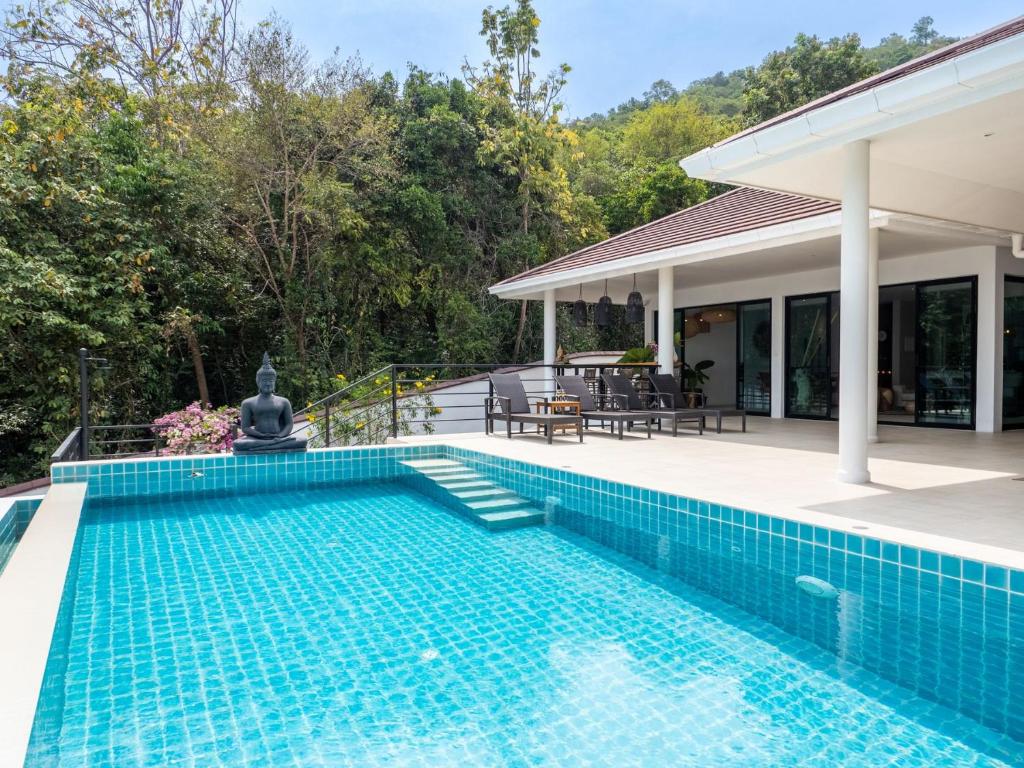 a swimming pool in front of a house at Tropical Sea View 2Br Private Pool Villa in Plai Laem