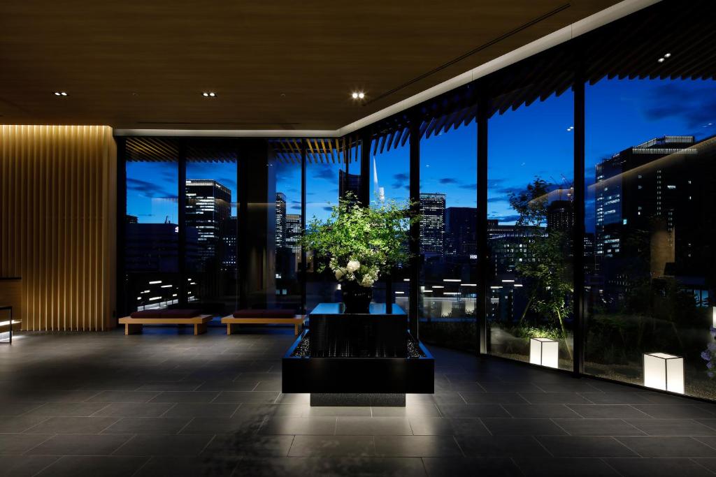 a lobby with a view of a city at night at Hotel Yaenomidori Tokyo in Tokyo