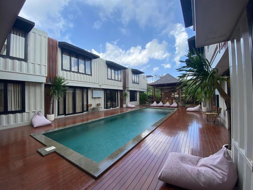 a swimming pool in the middle of a building at Allende Canggu in Canggu