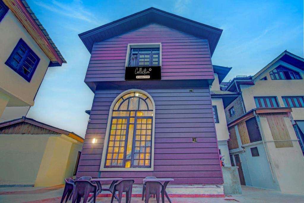 a purple building with chairs in front of it at Collection O NIT Srinagar Formerly Main Street Inn in Srinagar