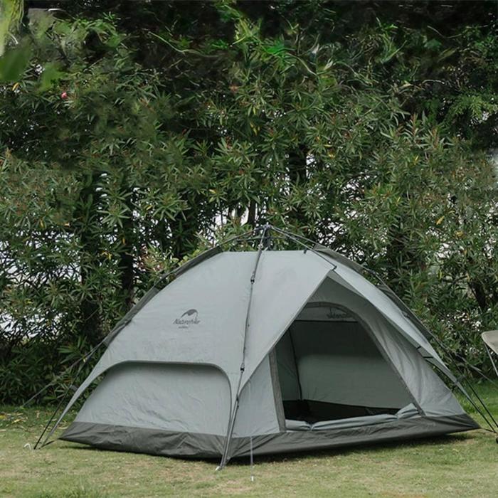 a tent sitting in the grass under a tree at Namdong Waterfall & Eco Resort in Luang Prabang