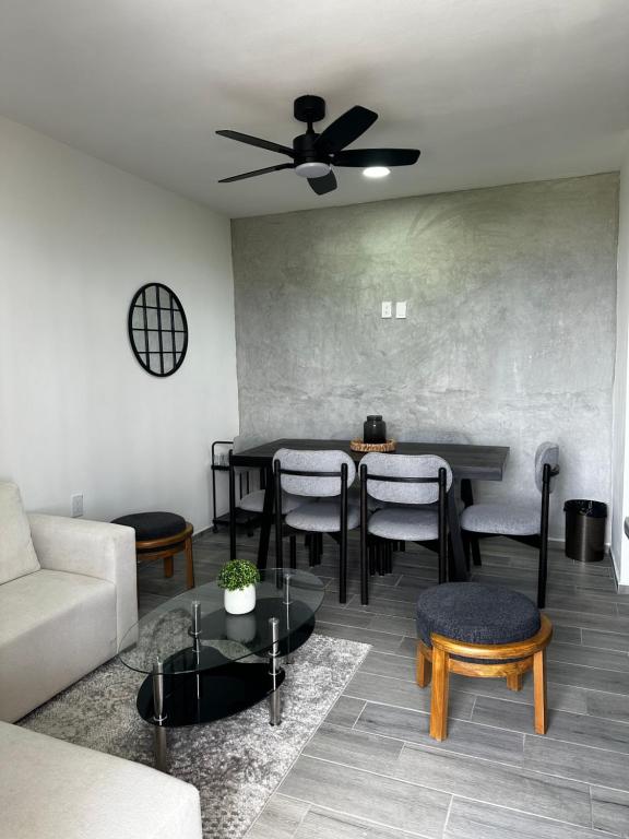 a living room with a couch and a table and chairs at Depto Vista Cañón del Sumidero in Cerro Hueco