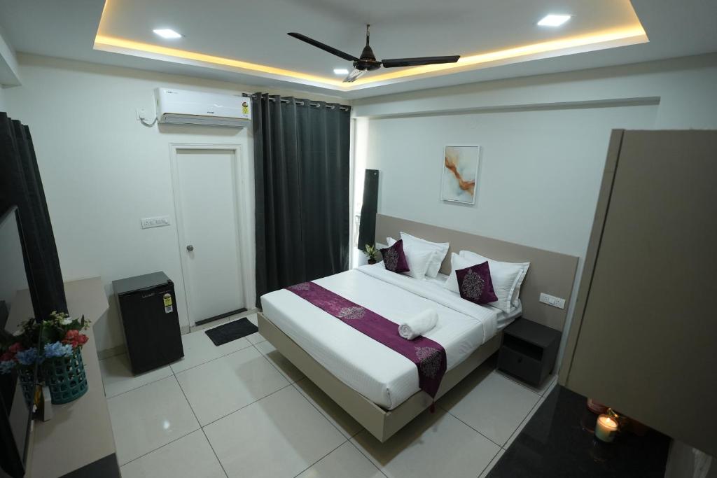 a hotel room with a bed in a room at Hotel Flamount Arka Studios in Hyderabad