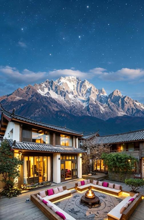 a resort with a view of a snow covered mountain at 丽江无尔雪山下泳池花园民宿 in Lijiang