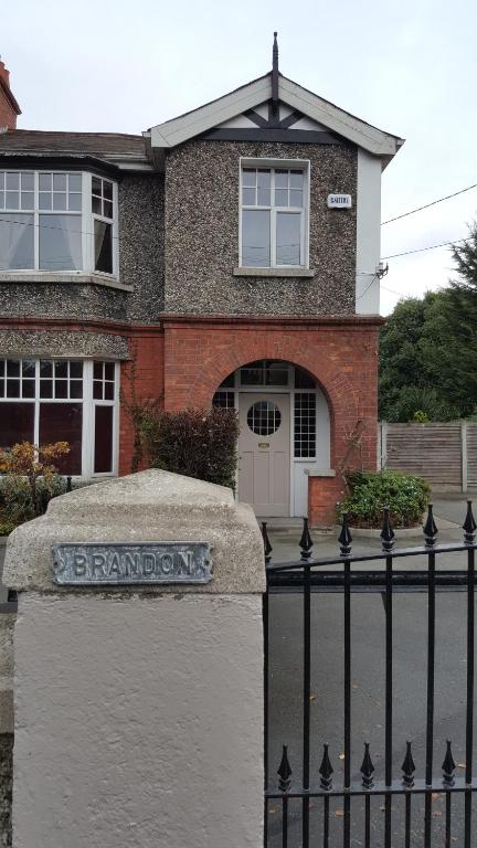 a brick house with a sign in front of a fence at Silver Eagle in Dublin