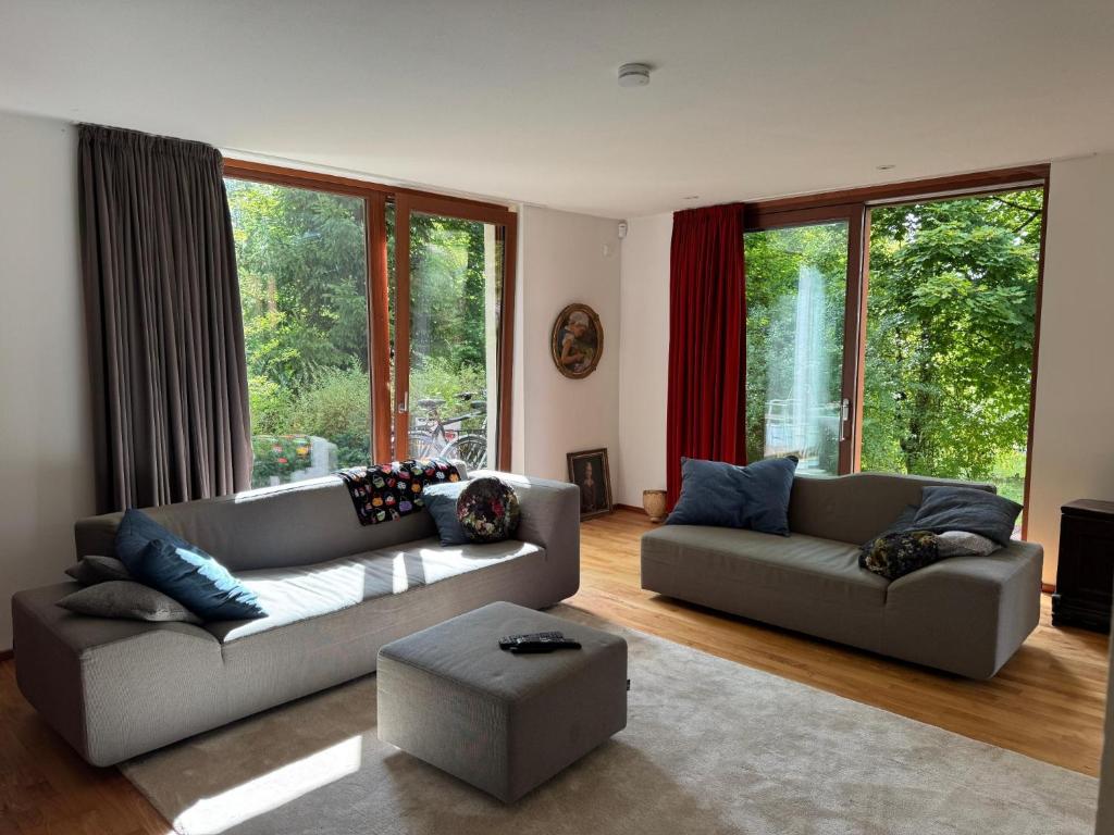 a living room with two couches and a large window at Haus Titschendorf in Wurzbach