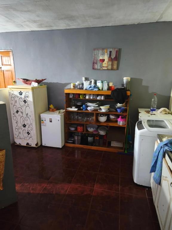 a kitchen with two refrigerators and a counter with a refrigerator at Hare maohi in Hanga Roa