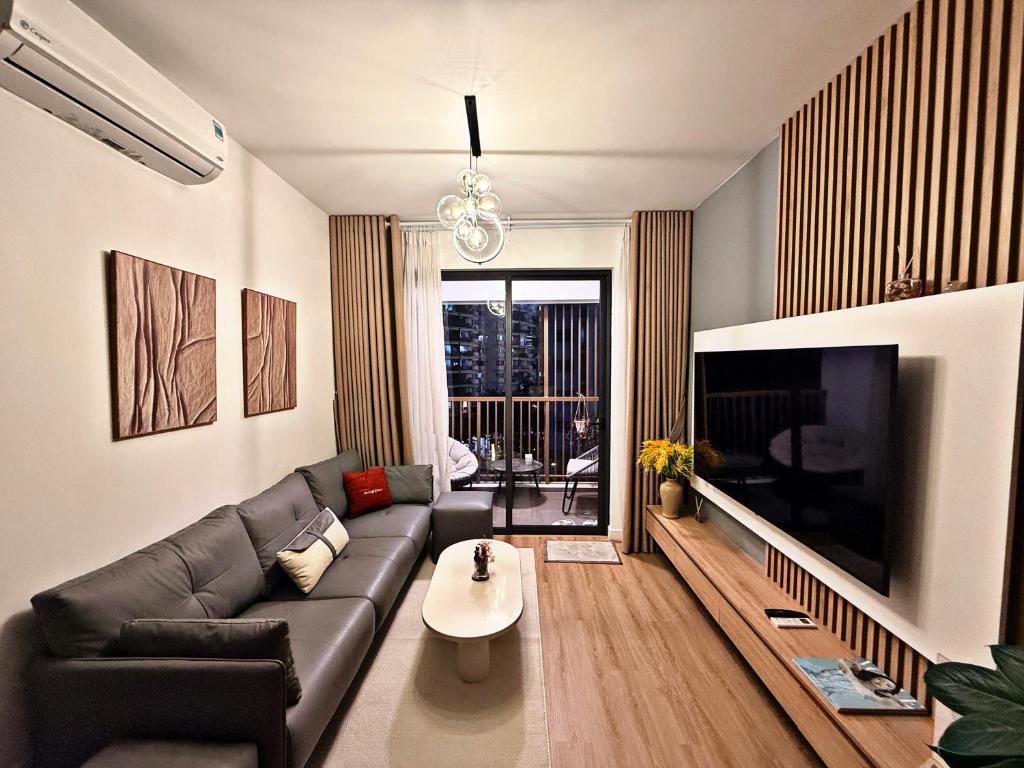 a living room with a couch and a large television at Căn Hộ Biên Hoà in Bien Hoa