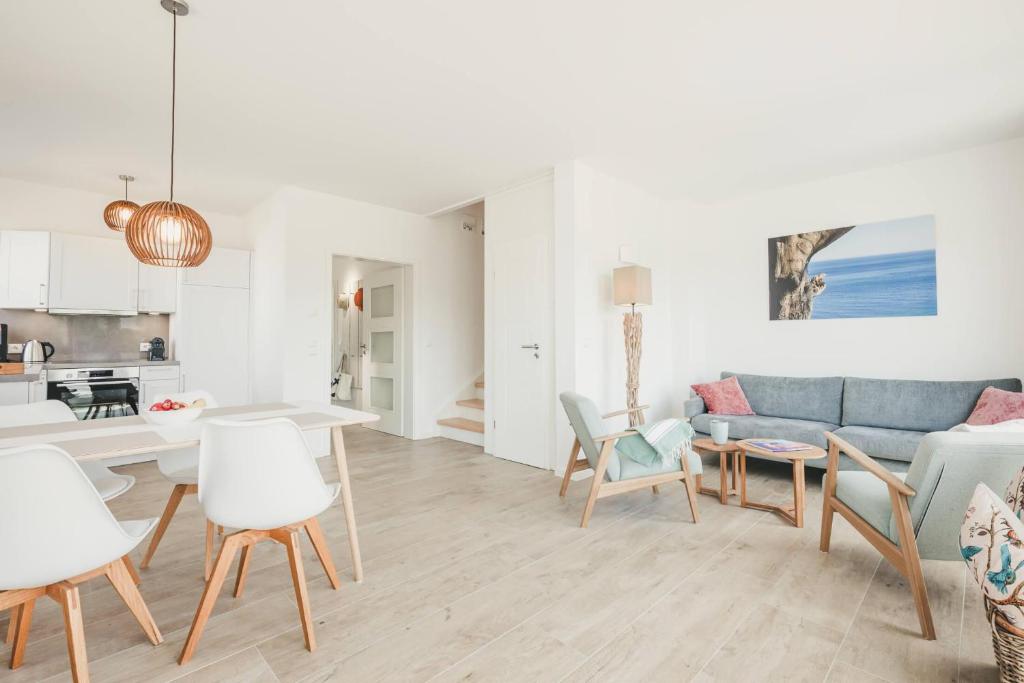 a living room with a couch and a table at Boddenruh in Fuhlendorf