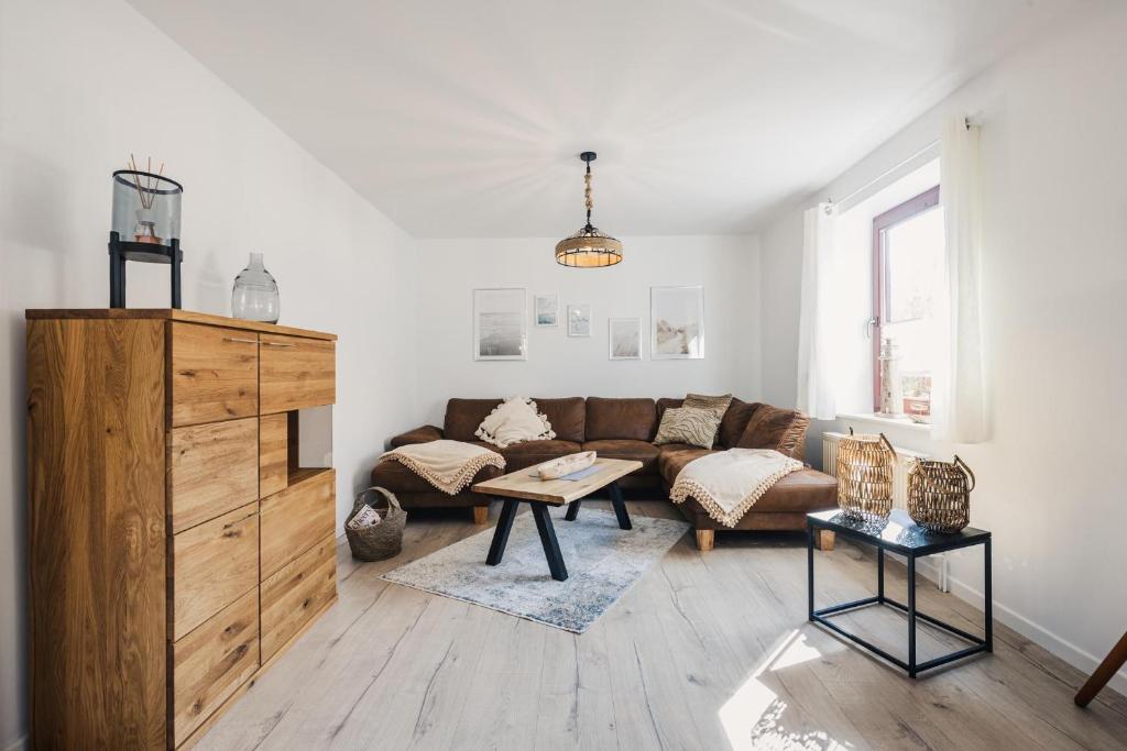 a living room with a couch and a table at Gartenidyll in Zingst