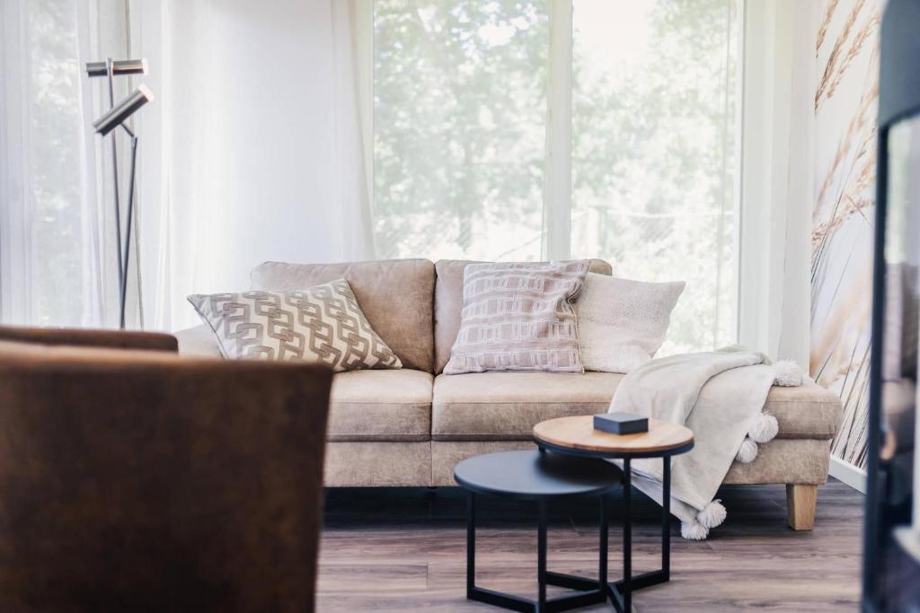 a living room with a couch and a table at Sommersonne in Zingst