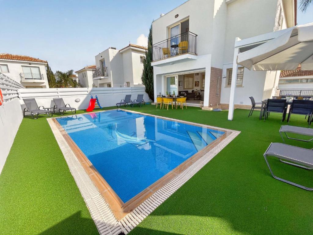 a swimming pool in the backyard of a house at Villa Allegra in Protaras