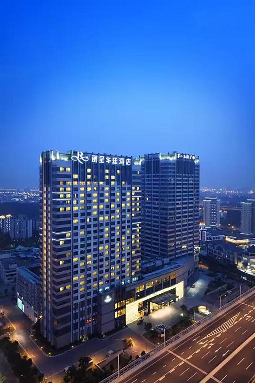 a large building in a city at night at Grand Rezen Hotel Wuxi in Wuxi