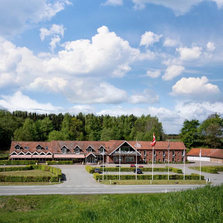a large building with a road in front of it at Nilles Kro in Sabro