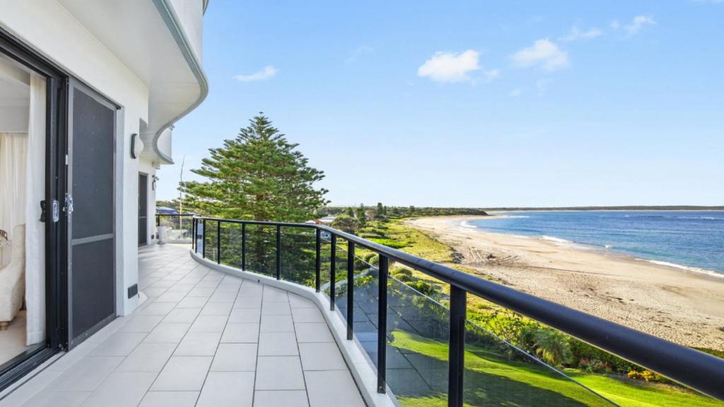 a balcony with a view of the beach at 'Aloha Beach Retreat' by HolidayCo in Norah