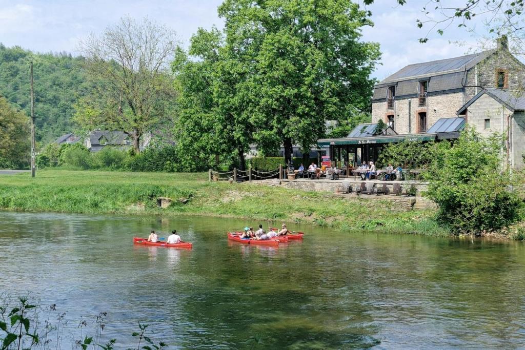 a group of people in kayaks on a river at Hôtel La Ferme de Sy in Ferrières