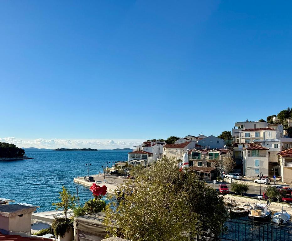 a town by the water with houses and boats at Lavanda in Tribunj