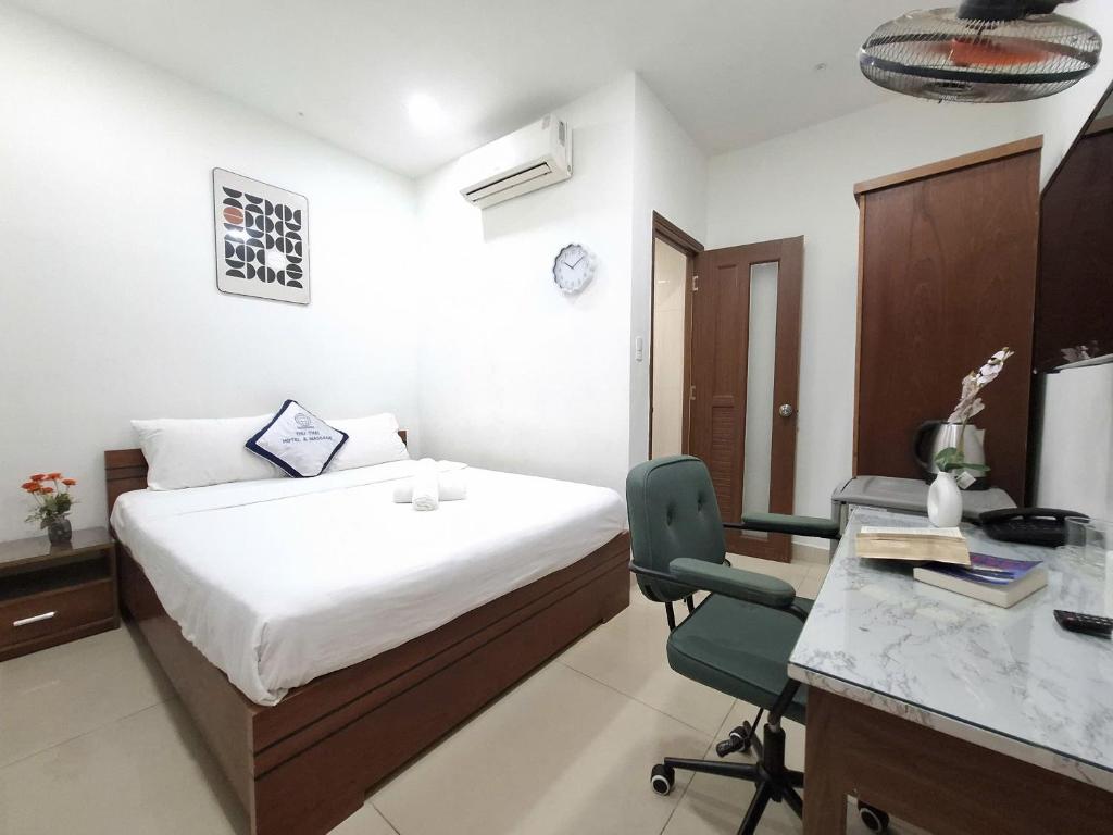 a bedroom with a bed and a desk and a computer at Lunar Stay HCM in Ho Chi Minh City