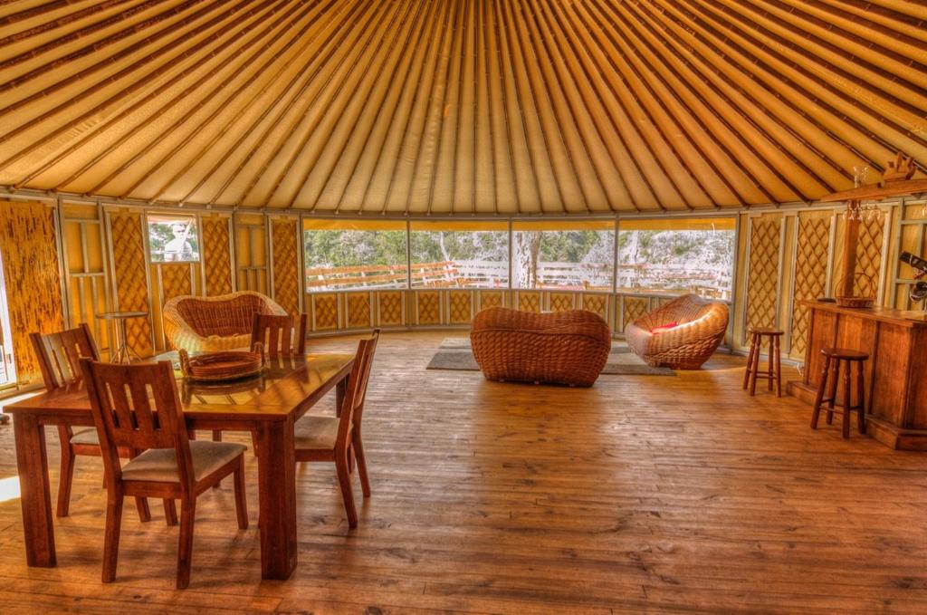 a dining room with a table and chairs in a tent at Fundo Panguilemu in Coihaique