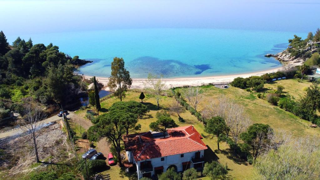 an aerial view of a house on a hill next to a beach at Hacienda Beachfront Villa, Spathies in Nikiti