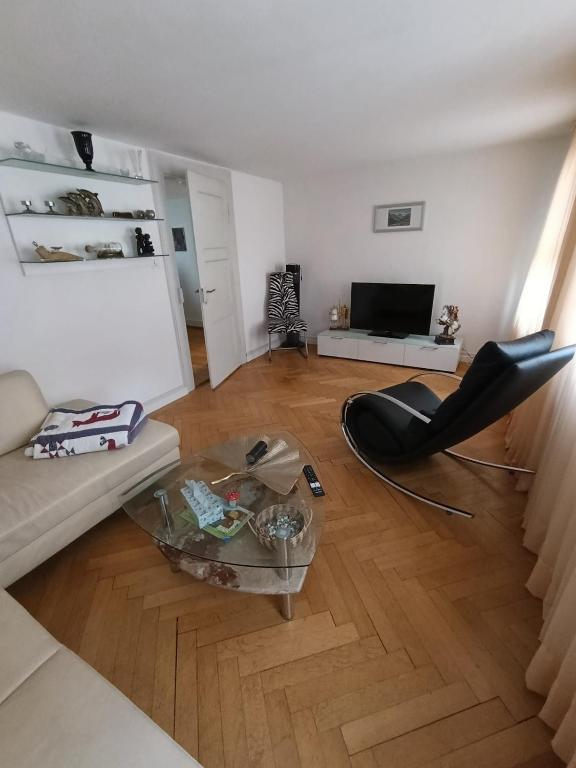 a living room with a couch and a table at Apartment on 2 floors in Stäfa