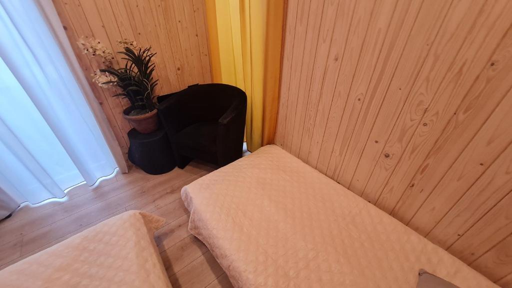 a corner of a room with a bench and a plant at Jomas & Baltic beach in Jūrmala