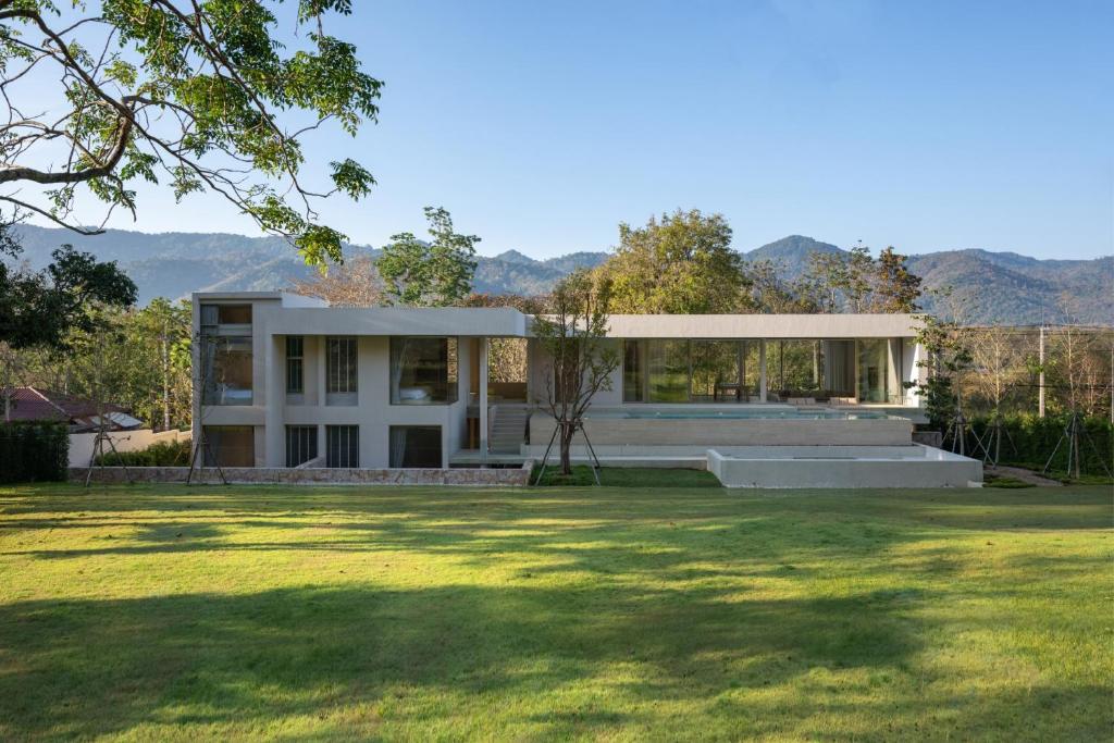 a house with a view of a yard at Number Three Pool Villa Khaoyai in Ban Tha Maprang